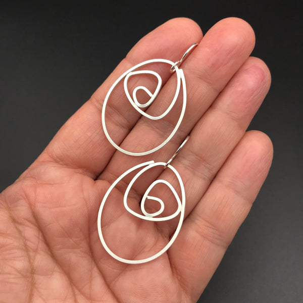 Labyrinth Earrings Large, sterling silver dangle earrings, matte finish shown on hand for scale