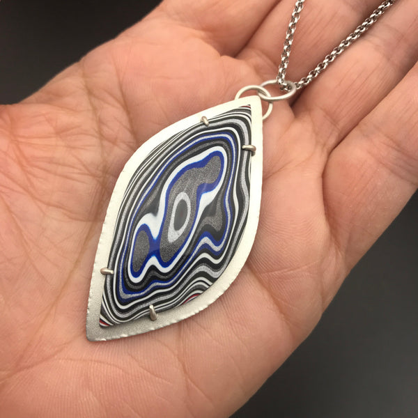 Fordite Pendant Necklace 2 by tkmetalarts, multicolor cabochon on sterling silver setting, comes on an 18 to 20 inch chain. Shown on hand for scale