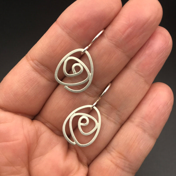 Labyrinth Earrings dangles sterling silver size small lightweight on hand to show scale